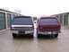 1988 Ford C-350 (Centurion Conversions) - Two SUVs with camper shells are parked in front of storage units.