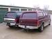 1988 Ford C-350 (Centurion Conversions) - Two Ford SUVs with camper shells are parked side-by-side in front of storage units.