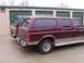 1988 Ford C-350 (Centurion Conversions) - Two trucks are parked in front of storage units, one maroon and one green.