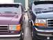 1988 Ford C-350 (Centurion Conversions) - Two Ford F-Series trucks, likely from the early 1990s, are parked closely together.
