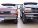 1988 Ford C-350 (Centurion Conversions) - Two Ford vans are parked next to each other, showing their front ends.