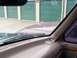 1988 Ford C-350 (Centurion Conversions) - Looking out from the driver's seat at a purple vehicle and green storage unit doors.