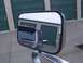 1988 Ford C-350 (Centurion Conversions) - Side mirror reflection shows the front passenger side of a 1988 Ford C-350 (Centurion Conversions) truck.