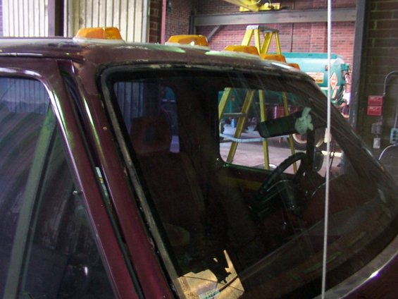 Maroon truck cab interior with orange cab lights, showing steering wheel and dashboard