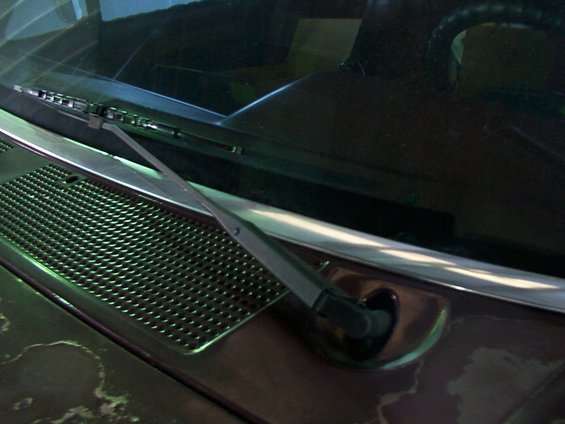 Brown vehicle cowl grille and windshield wiper arm