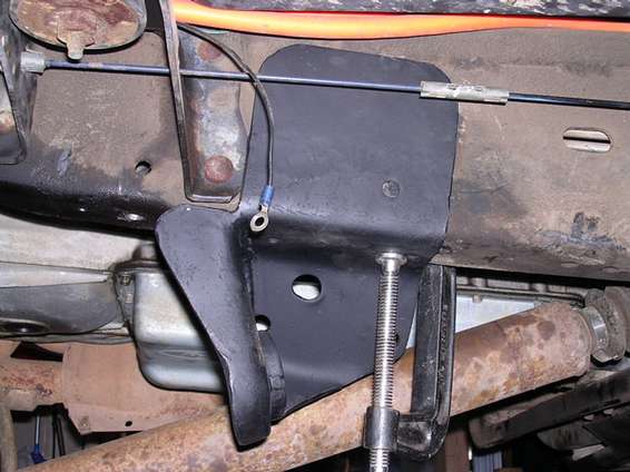 newbracketon.jpg temporarily secured.  Note how it is notched out for the body mount so I can push the axle forward to clear the rear of the front fender