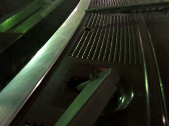 Windshield wiper mechanism with metal arm and perforated cover