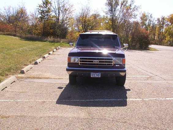 Front view of a maroon 1988 Ford C-350 (Centurion Conversions) truck parked in a lot