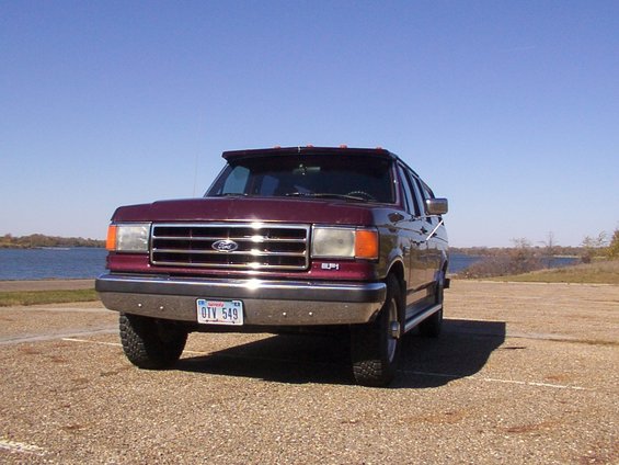 Maroon Ford SUV with a chrome grille and a license plate reading OTV 549