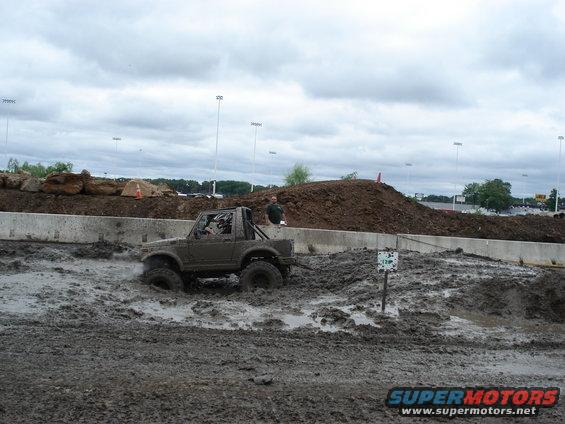 Suzuki Samurai driving through mud pit