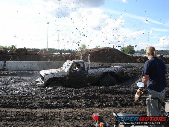 Mud bog truck stuck in mud, exhaust stacks visible