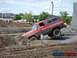 1990 Ford Bronco - Off-road vehicle attempts to navigate a challenging mud bog.