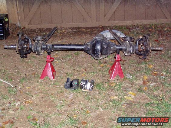 Ford F-250 rear axle assembly on jack stands with brake calipers nearby