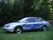 1999 Ford Taurus - Silver 1999 Ford Taurus with custom blue flame graphics and chrome wheels.