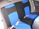 1999 Ford Taurus - The rear seat of a car features custom blue and black seat covers with visible seatbelts.
