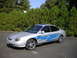 1999 Ford Taurus - This 1999 Ford Taurus features custom blue flame graphics and chrome wheels, parked outdoors.
