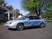 1999 Ford Taurus - This 1999 Ford Taurus features custom blue flame graphics and chrome wheels, parked in a suburban driveway.