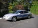1999 Ford Taurus - This 1999 Ford Taurus features a silver paint job with striking blue flame decals along its side.