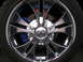 1999 Ford Taurus - Close-up of a shiny chrome wheel and blue brake caliper.