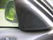 1999 Ford Taurus - Close-up of a car's interior door panel, showing a speaker grille and the side mirror.