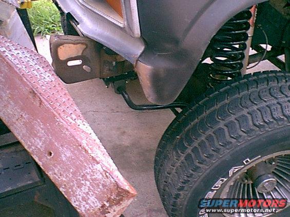 driversidenotcut.jpg The front fenders have a "Tooth" that hangs down on the front. i decided i woud remove it and set the bumper in the same place. here is the stock look (mine was dented so cutting was no issue anyway since i planed to replace, but if i replace i still cut the new one. I like this part gone.