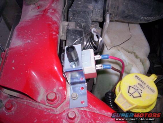 Engine bay wiring and washer fluid cap