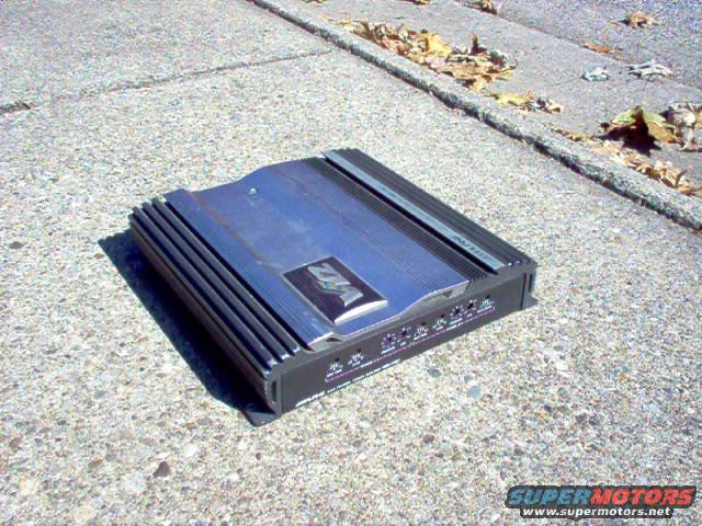 Car amplifier with 'VFL' logo on a concrete surface