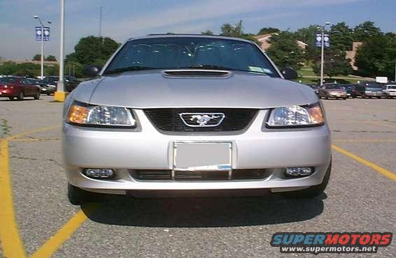 Front view of a silver 2000 Ford Mustang with a black grille and a horse emblem
