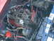 1986 Ford Bronco - Close-up view of a vehicle's engine bay, showing various components and wiring.