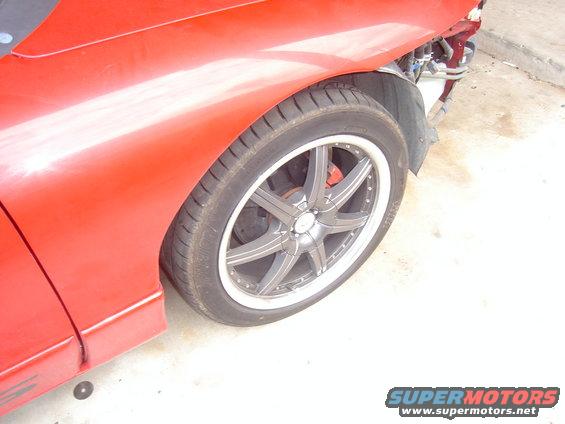 Red car fender and custom wheel with red brake caliper