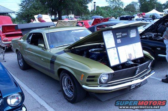 Green 1969 Ford Mustang Boss 302 with hood open, displaying information