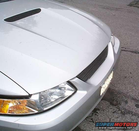 Silver 2000 Ford Mustang front end, showing custom grille and hood scoop