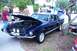 2006 Ford Mustang - A classic dark blue Ford Mustang Shelby GT500 is displayed with its hood open at an outdoor event.