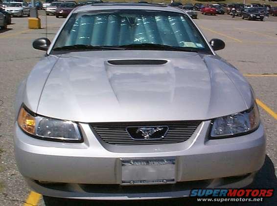 Silver 2000 Ford Mustang front view with custom grille and sunshade