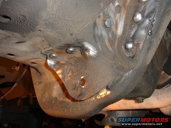 Close-up of welded metal on a vehicle's frame, likely during a lift installation