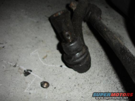 worn ball joint and tie rod end on concrete floor