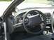 2000 Ford Mustang - The interior of a 2000 Ford Mustang features a steering wheel, dashboard, and aftermarket gauges.