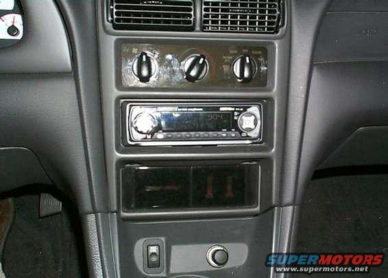 Interior dashboard of a 2000 Ford Mustang with aftermarket radio