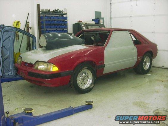 Red and gray 1990 Ford Mustang with hood scoop