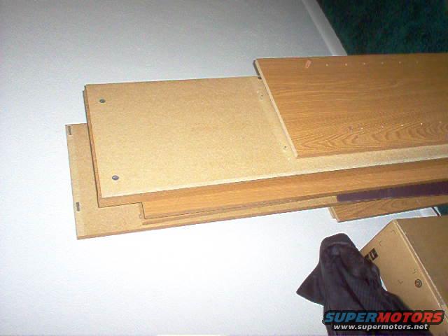 Stack of wooden boards, one with wood grain pattern