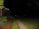 1988 Ford C-350 (Centurion Conversions) - A dark pickup truck is parked in a driveway at night, illuminated by nearby lights.