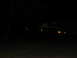 1988 Ford C-350 (Centurion Conversions) - A blurry truck is visible at night, with its headlights illuminated.