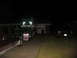 1988 Ford C-350 (Centurion Conversions) - Two trucks are parked in a driveway at night in front of a garage.