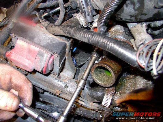 The upper bolt, on the passenger's side, is easy enough to access using 1/4" drive socket, extension and ratchet, once a wrench has broke it loose.