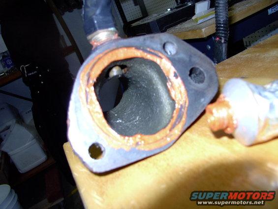 Lay a bit of sealant on the inside of the now cleaned T-stat housing locating indent. I use Permatex Ultra-Copper on everything under the hood, because it's high heat and sensor safe.