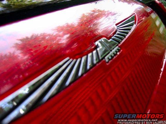 Red car emblem with a bird design on a red car body
