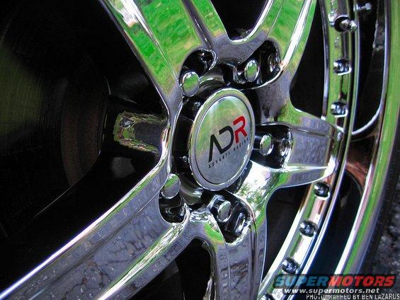 Close-up of a chrome wheel with a center cap that says ADR Advanti Racing