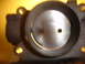 1993 Mazda MX-3 - Throttle body interior showing the butterfly valve and mounting points.