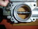 1993 Mazda MX-3 - This is a close-up view of a throttle body, a critical component in a vehicle's engine system.