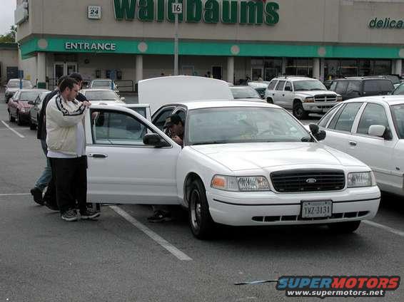 1998 Ford Crown Victoria front view, white, with doors open